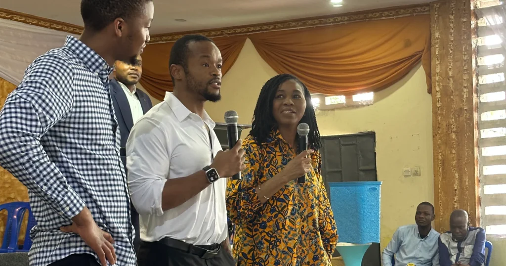 Christophe, Patrick, and Theresa speak in front of the congregation of the church founded by Theresa’s father.